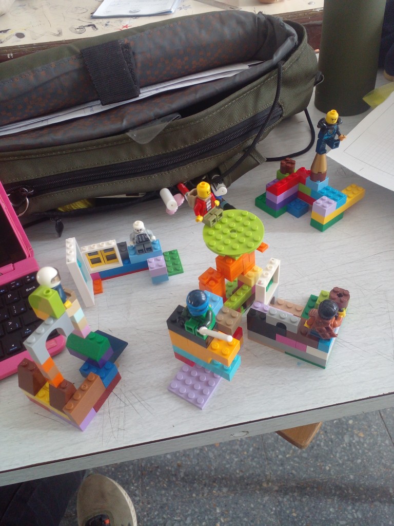 A bunch of small Lego brick buildings, some with Lego dudes on 'em. I use them to teach perspective in Technical Drawing classes.